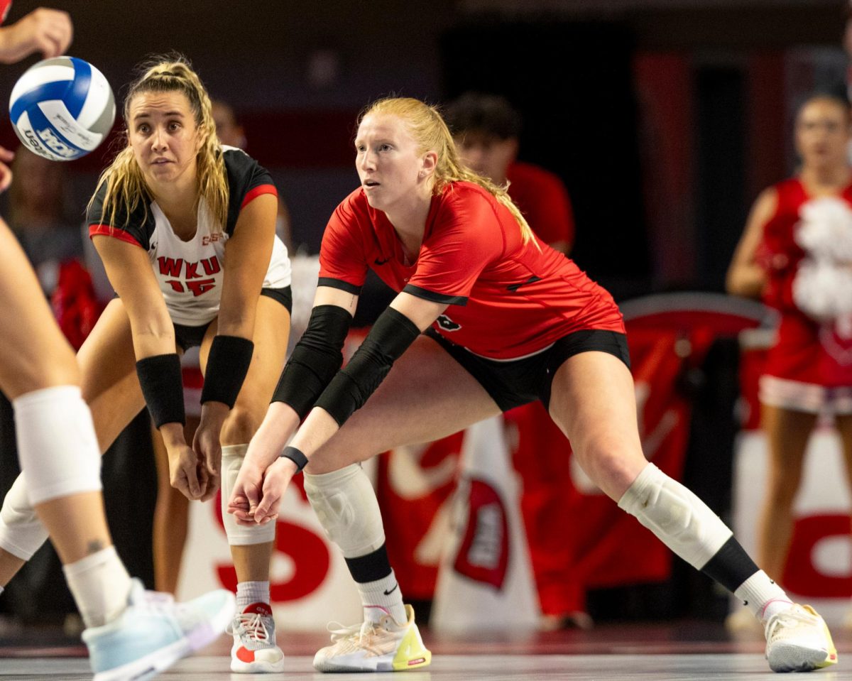 WKU defensive specialist Abby Schaefer and outside hitter Kaylee Cox attempt for a dig during the game against Arkansas State University in Diddle Arena on Friday, Sept. 20, 2024.