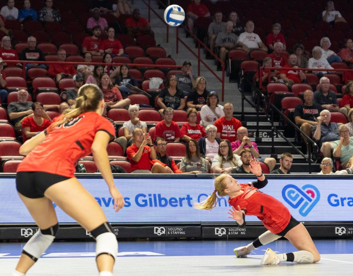 WKU outside hitter Kaylee Cox bends in reaction to digging the ball against Arkansas State University in Diddle Arena on Friday, Sept. 20, 2024. 