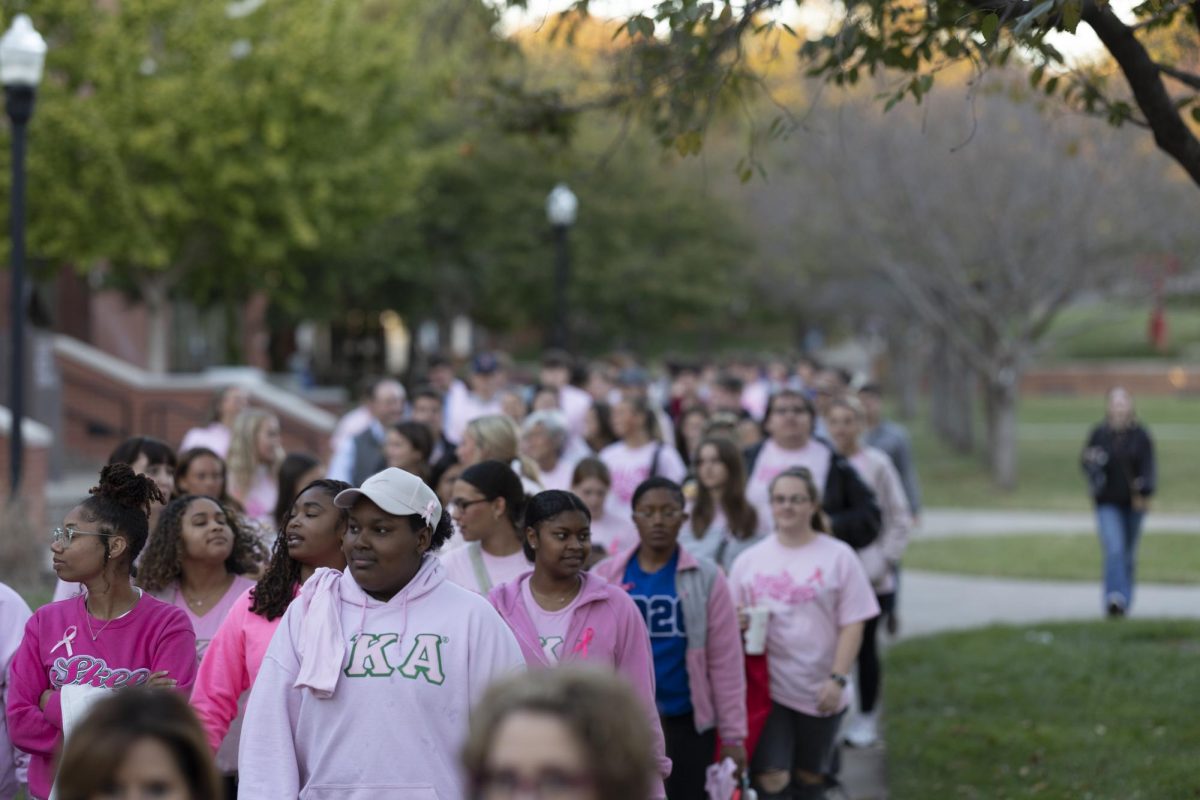 Students walk through Centennial Mall in the Pink Walk hosted by SGA, PAN, IFC and NHC honoring Breast Cancer Awareness Month on Oct. 17, 2024.