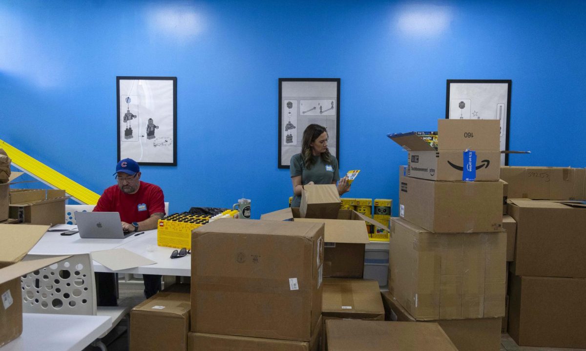 Tony Lopez and his wife Jenny Lopez work with new inventory for their local Bricks & Minifigs store on Scottsville Road in Bowling Green.