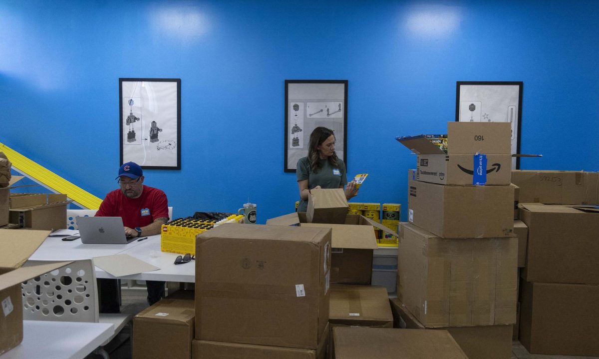 Tony Lopez and his wife Jenny Lopez work with new inventory for their local Bricks & Minifigs store on Scottsville Road in Bowling Green.