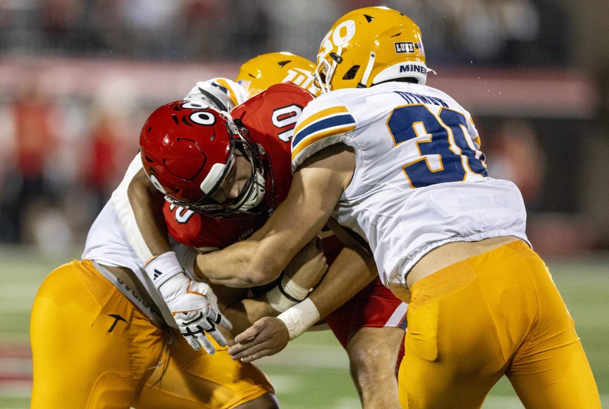 Western Kentucky Hilltoppers quarterback Caden Veltkamp (10) is tacked by two UTEP defenders during WKU’s game against The University of Texas at El Paso in Bowing Green, Ky. on Thursday, Oct. 10, 2024. 