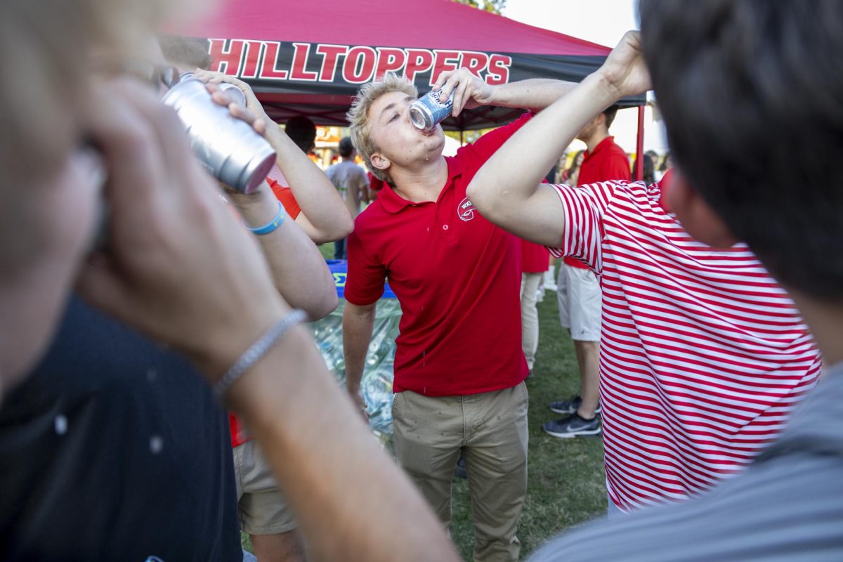 Dallas Wirth, a junior marketing major, shotguns a beer with his fraternity brothers during the tailgate before WKU’s game against The University of Texas at El Paso in Bowing Green, Ky. on Thursday, Oct. 10, 2024. 