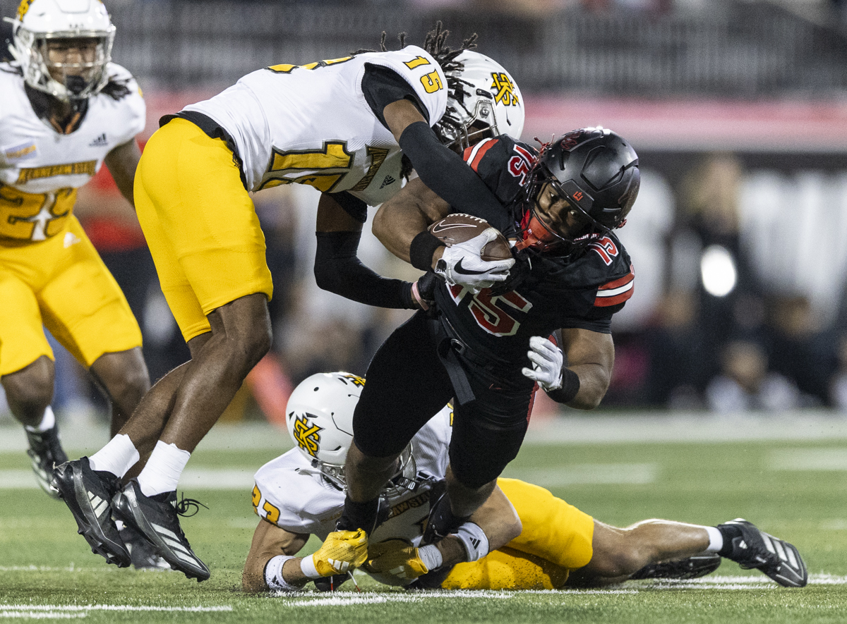 Kennesaw State Owls defensive back Jayven Williams (15) tackles Western Kentucky Hilltoppers wide receiver K.D. Hutchinson (15) during a game at L.T. Smith Stadium on Wednesday, Oct. 30, 2024.