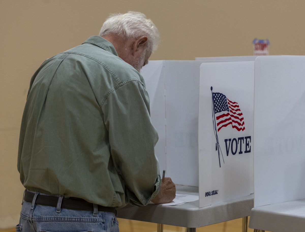 A voter casts their vote for the 2024 election during early voting at Living Hope Baptist Church on October 31 2024.