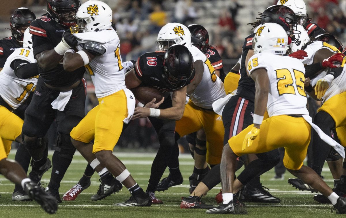 Western Kentucky Hilltoppers quarterback Caden Veltkamp (10) pushes through the Kennesaw State defensive line in the L.T. Smith Stadium on Wednesday, Oct. 30, 2024.