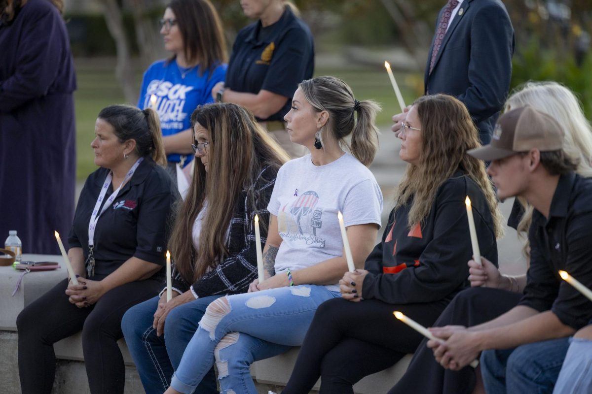 The crowd sits and listens to speeches delivered during candlelight vigil held for victims of domestic abuse on Oct. 24, 2024.