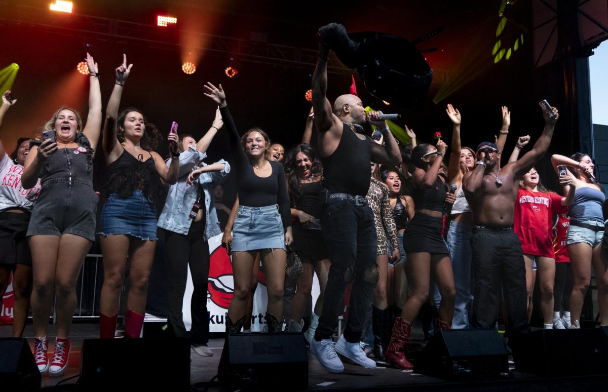 Flo Rida brings WKU students on stage to sing with him during his performance on South Lawn prior to the WKU and Kennesaw State University football game on Wednesday, Oct. 30, 2024.