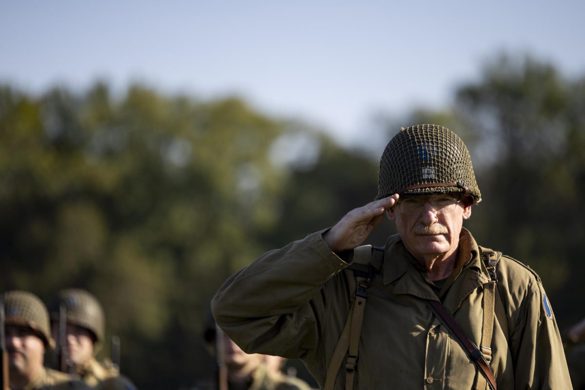 The commander of the 29th ‘Blue and Grey’ Division salutes during the playing of the national anthem ahead of the 6th annual Operation Anvil reenactment at Phil Moore Park on Friday, Oct. 4, 2024.