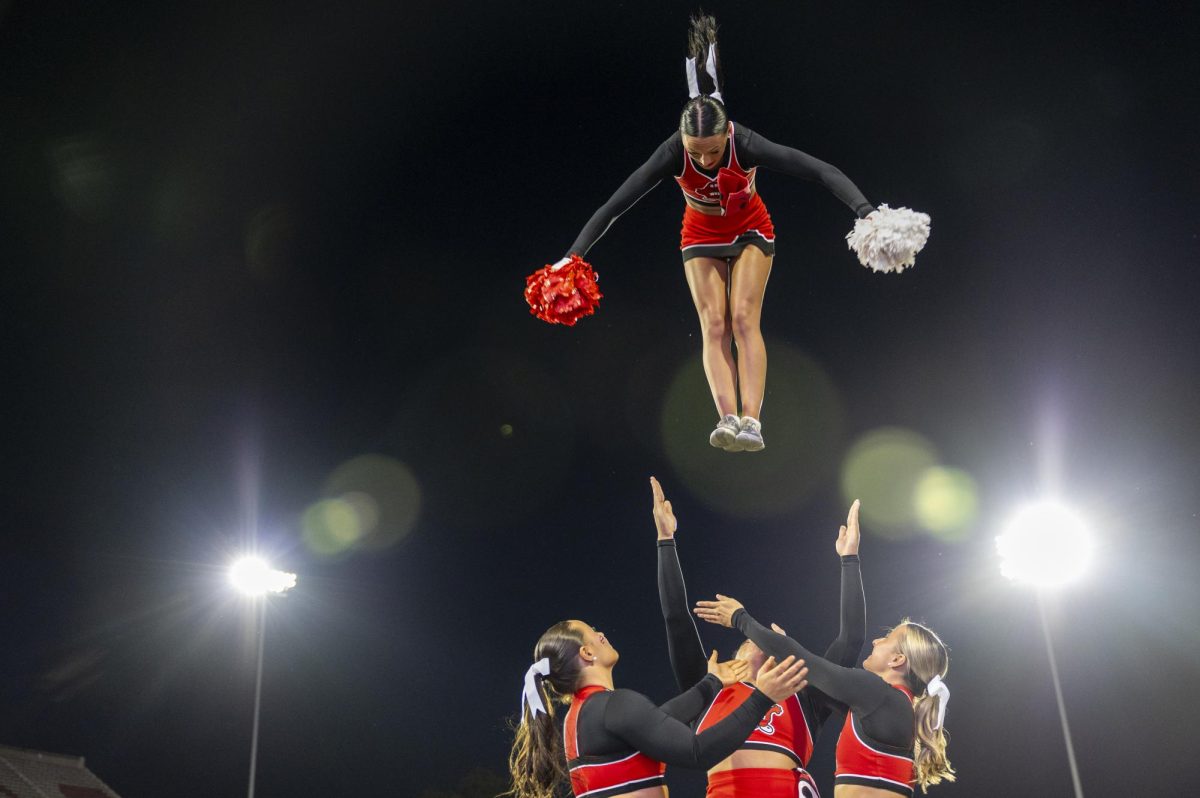 A WKU cheerleader flies though the air before WKU’s game against The University of Texas at El Paso in Bowing Green, Ky. on Thursday, Oct. 10, 2024. 