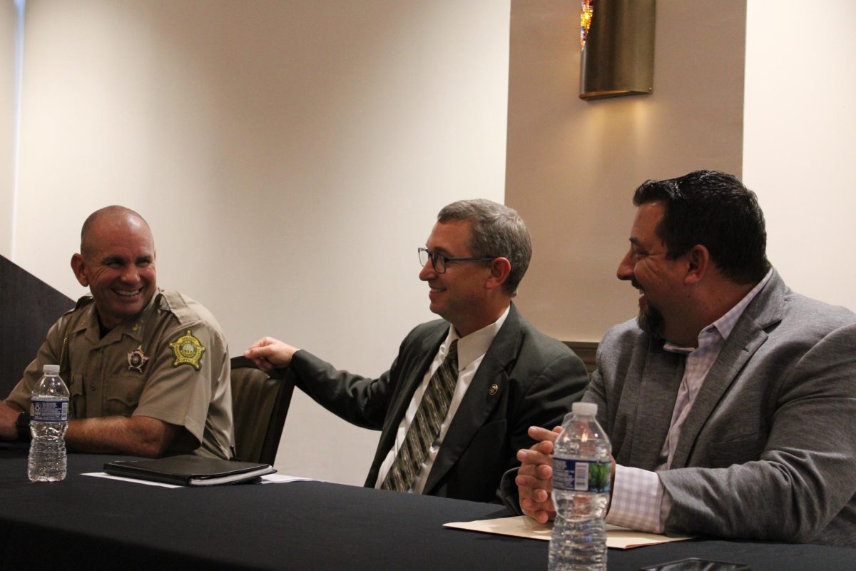 From left: Chief Deputy Kevin Wiles of Warren County Sheriff’s Department, and Agents Jamie Gordon and Micheal Johnson of the Warren County drug task force laugh while talking before speaking at the Department of Society, Culture, Crime and Justice's law enforcement career panel on Sept. 28 in the Honors College and International Center.