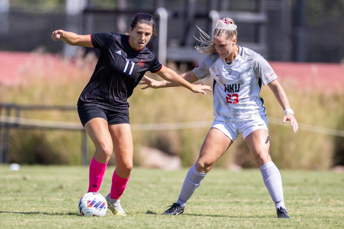 Jacksonville State University forward Naroa Domenech (11) kicks the ball away from Western Kentucky University defender Kendall Wale (23) during a match at the WKU Soccer Complex on Sunday, Oct. 6, 2024. 