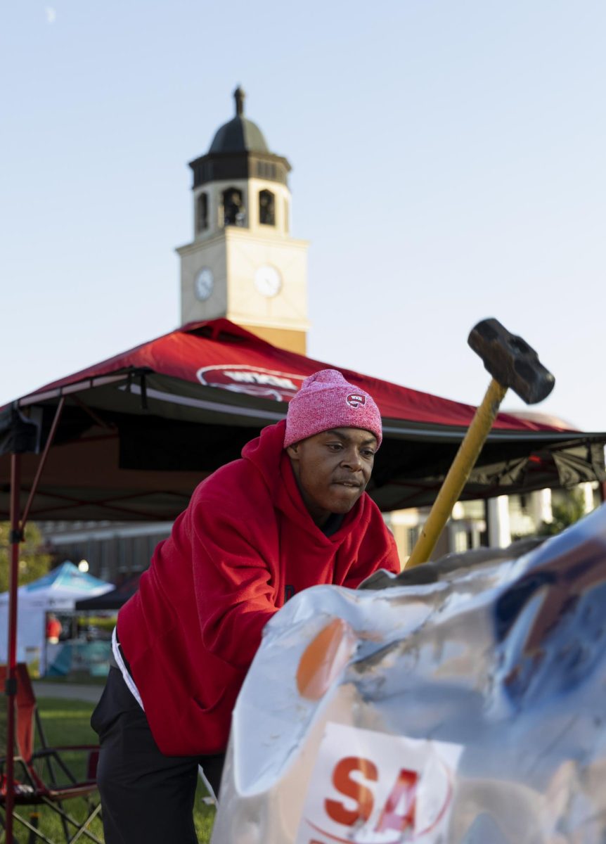 Chauncey Freeman smashes the car during the tailgate on south lawn before the Western Kentucky football game against the University Texas at El Paso on Thursday, October 10, 2024. WKU won 44-17