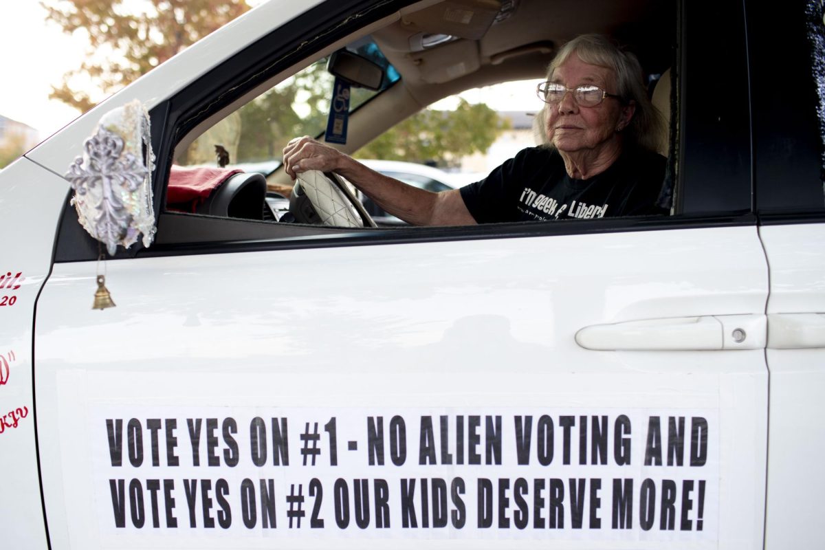 Lynda Farley of Edmonton, adorns her 2010 Kia Sedona nicknamed the “Victory Van” with political signage supporting state legislative Amendments 1 and 2 before the Americans for Prosperity “Yes On 2” rally at the La Gala event center in downtown Bowling Green on Monday, Oct. 28, 2024.  “I am excited anytime people are ready to uphold freedom,” Farley said. 