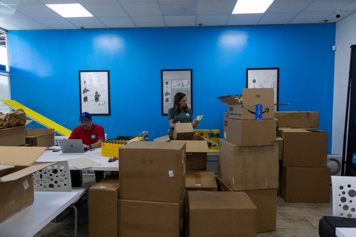 Tony Lopez and his wife Jenny Lopez work with new inventory for their local Bricks & Minifigs store on Scottsville Road in Bowling Green.