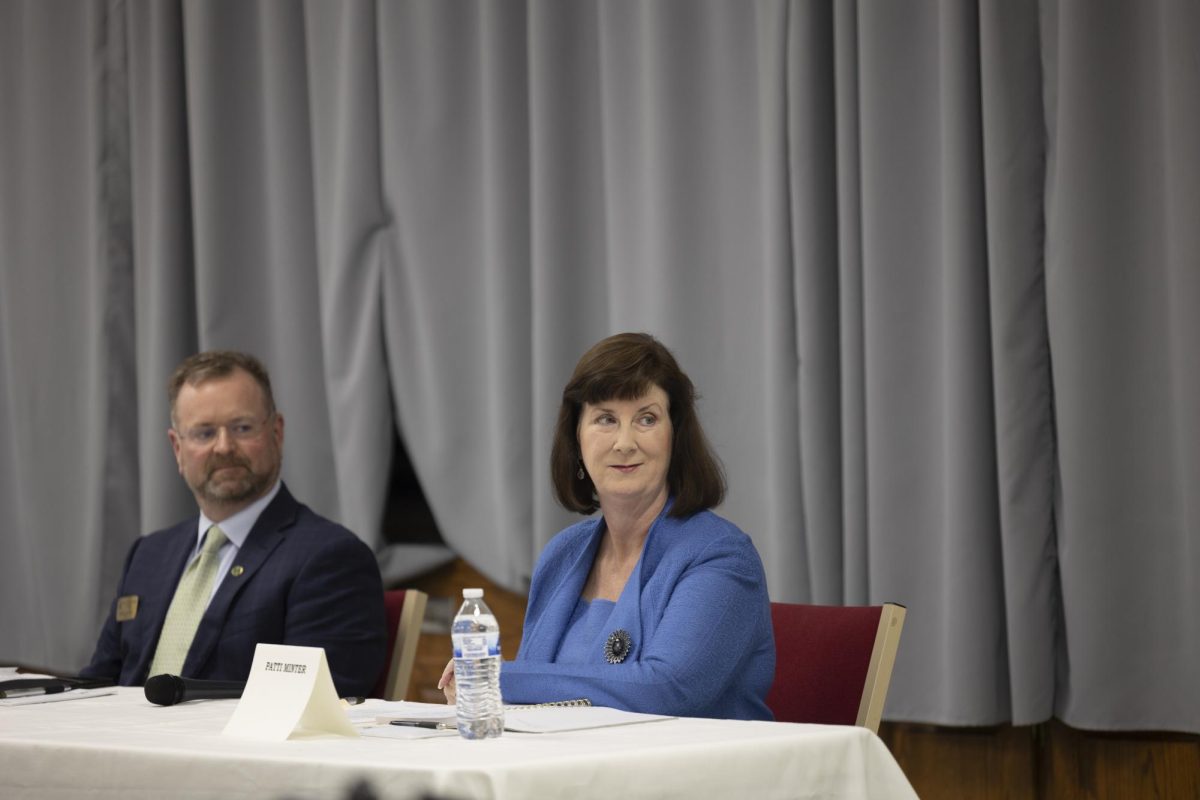 Mayor Todd Alcott and candidate Patti Minter listen to questions during the Mayors Forum held by the NAACP at State Street Baptist Church on Monday, Oct. 21, 2024. 