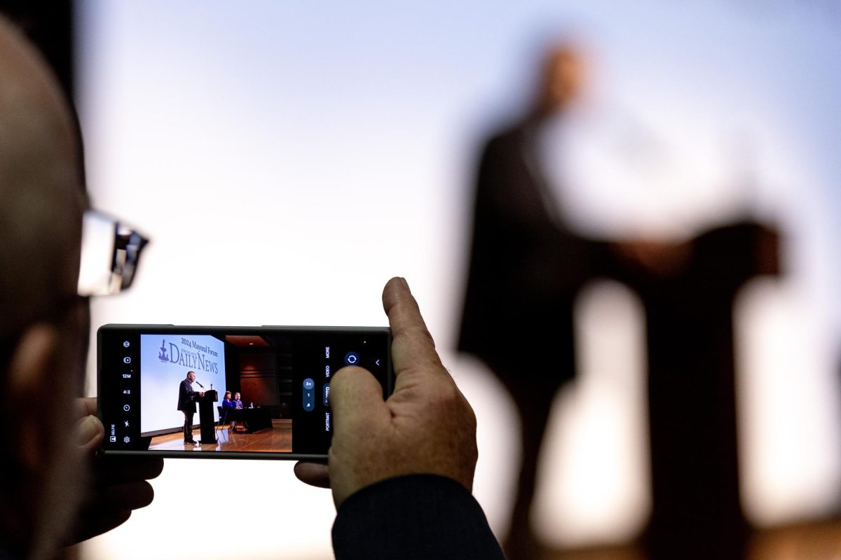 Joe Imel, publisher of the Bowling Green Daily News, snaps a photo of the candidates’ opening speeches before beginning the Bowling Green Daily News’ Mayoral Forum at Bowling Green Junior High School on Oct. 14, 2024. 