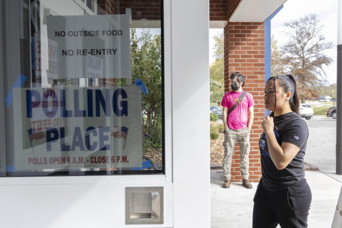 A voter walks in the door to vote during the last day of voting on Tuesday, Nov. 5, 2024 at Warren Central High School in Bowling Green. 