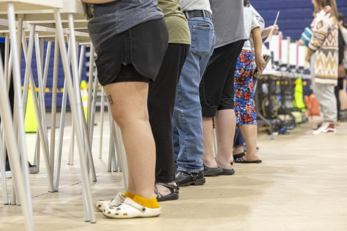 Voters legs align as they vote during the last day of voting on Tuesday, Nov. 5, 2024 at Warren Central High School.