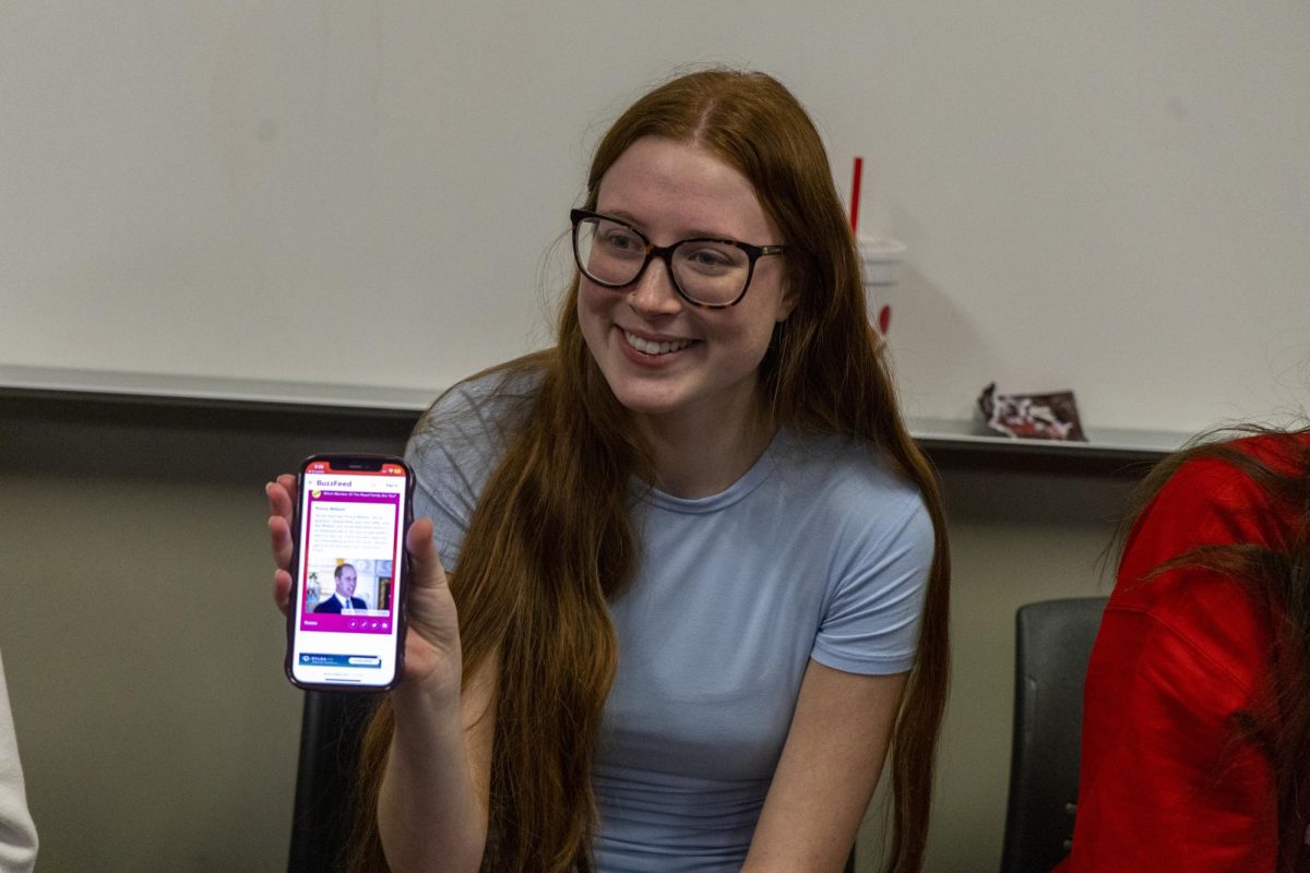 Ansley Pennington show a quiz result on her phone after she takes a quiz to see which royal family member she is on Buzz Feed at  the WKU Royal family Fan Club trivia night on Wednesday, Nov. 6, 2024. 