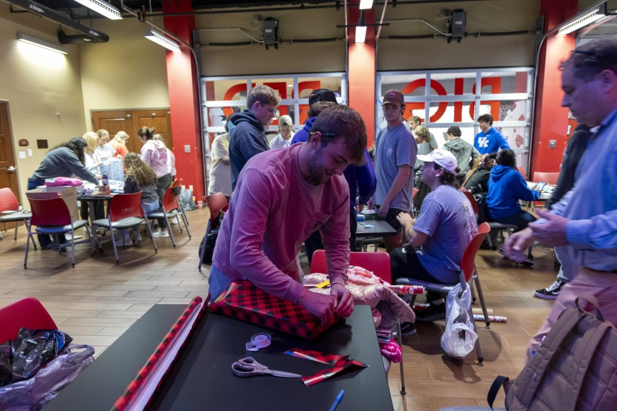 Neal Aldridge, member of FarmHouse fraternity, wraps gifts for the Salvation Army Angel Tree program at DSU on Tuesday, Nov. 19, 2024.