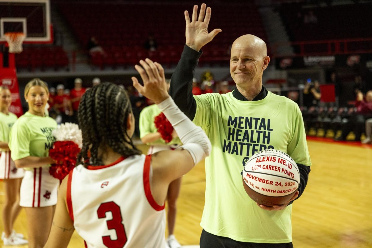 Head coach Greg Collins congratulates guard Alexis Mead (3) on her over 1,000 career points before the Lady Toppers game against Tennessee State University in Bowing Green, Ky. on Wednesday, Nov. 27, 2024.