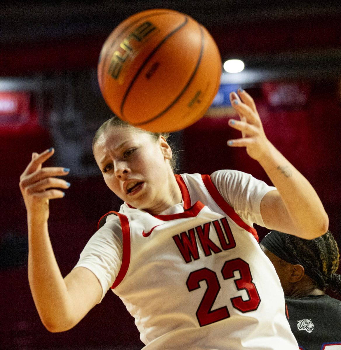 WKU forward Zsofia Telegdy (23) looks for the ball after it is knocked loose during the Lady Toppers game against Tennessee State University in Bowing Green, Ky. on Wednesday, Nov. 27, 2024.