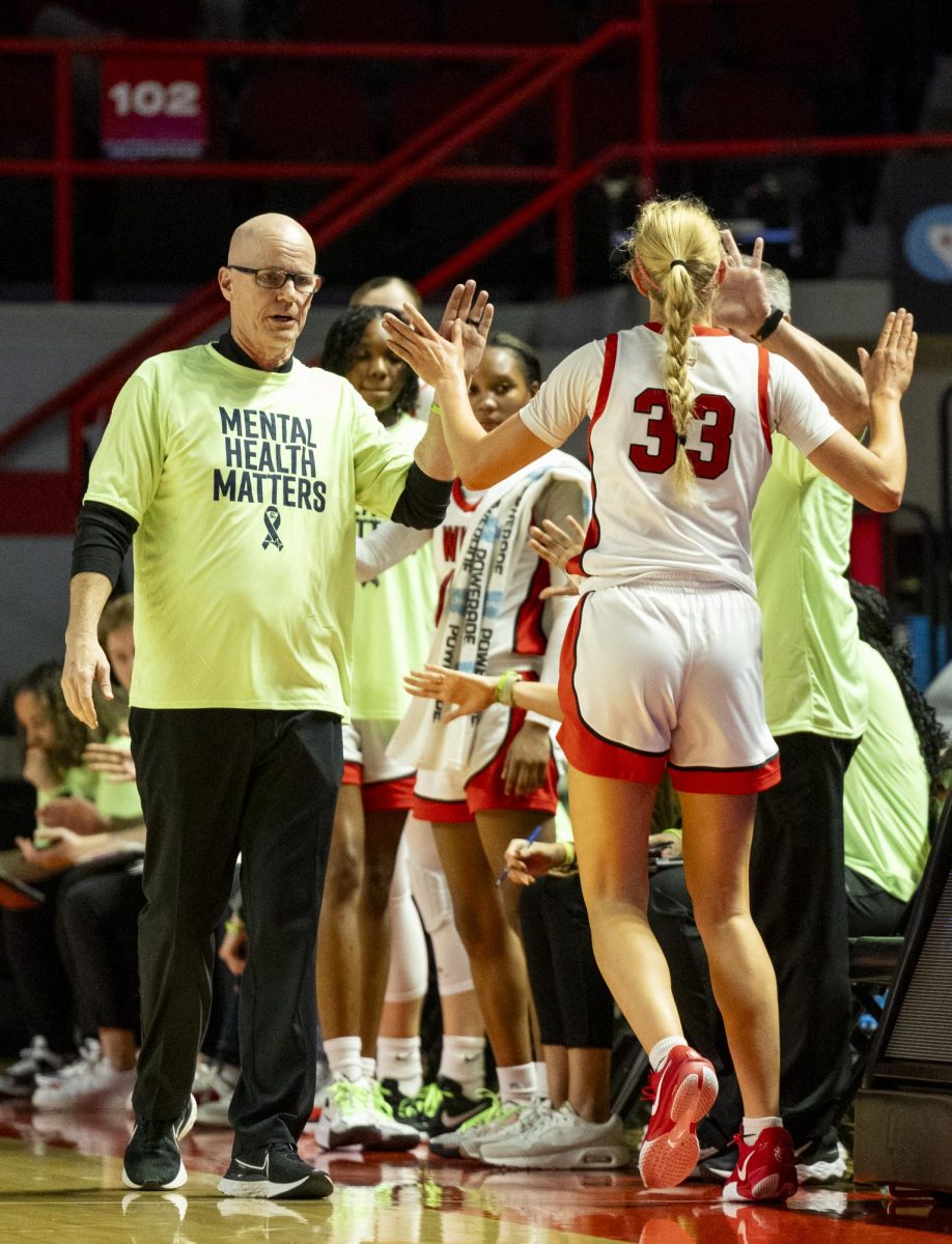 WKU head coach Greg Collins high fives guard Josie Gilvin (33) during the Lady Toppers game against Tennessee State University in Bowing Green, Ky. on Wednesday, Nov. 27, 2024.