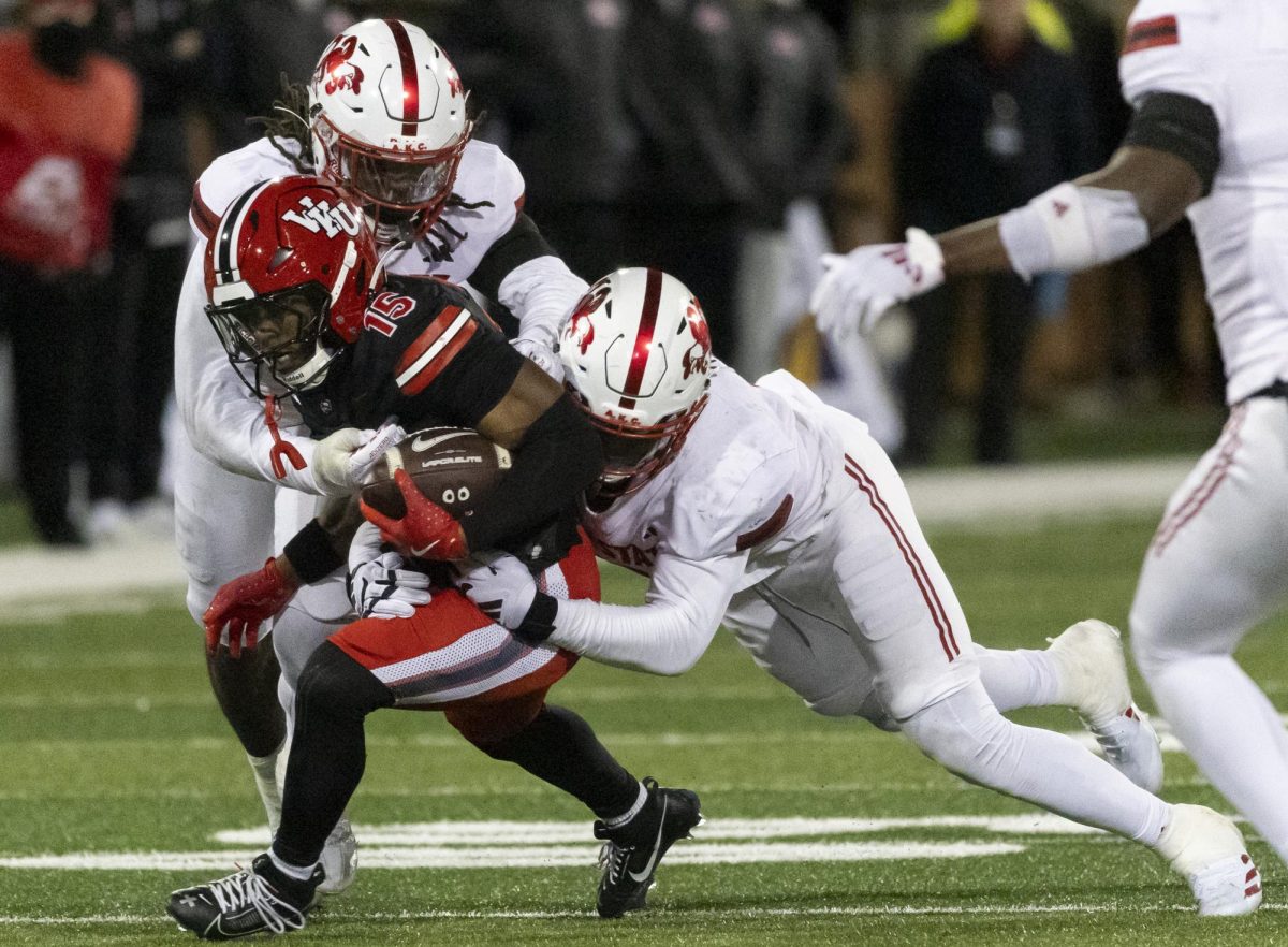 Western Kentucky Hilltoppers wide receiver K.D. Hutchinson (15) fights with Jax State defenders to secure yardage during WKU’s game against Jacksonville State University in Bowing Green, Ky. on Friday, Nov. 29, 2024. 