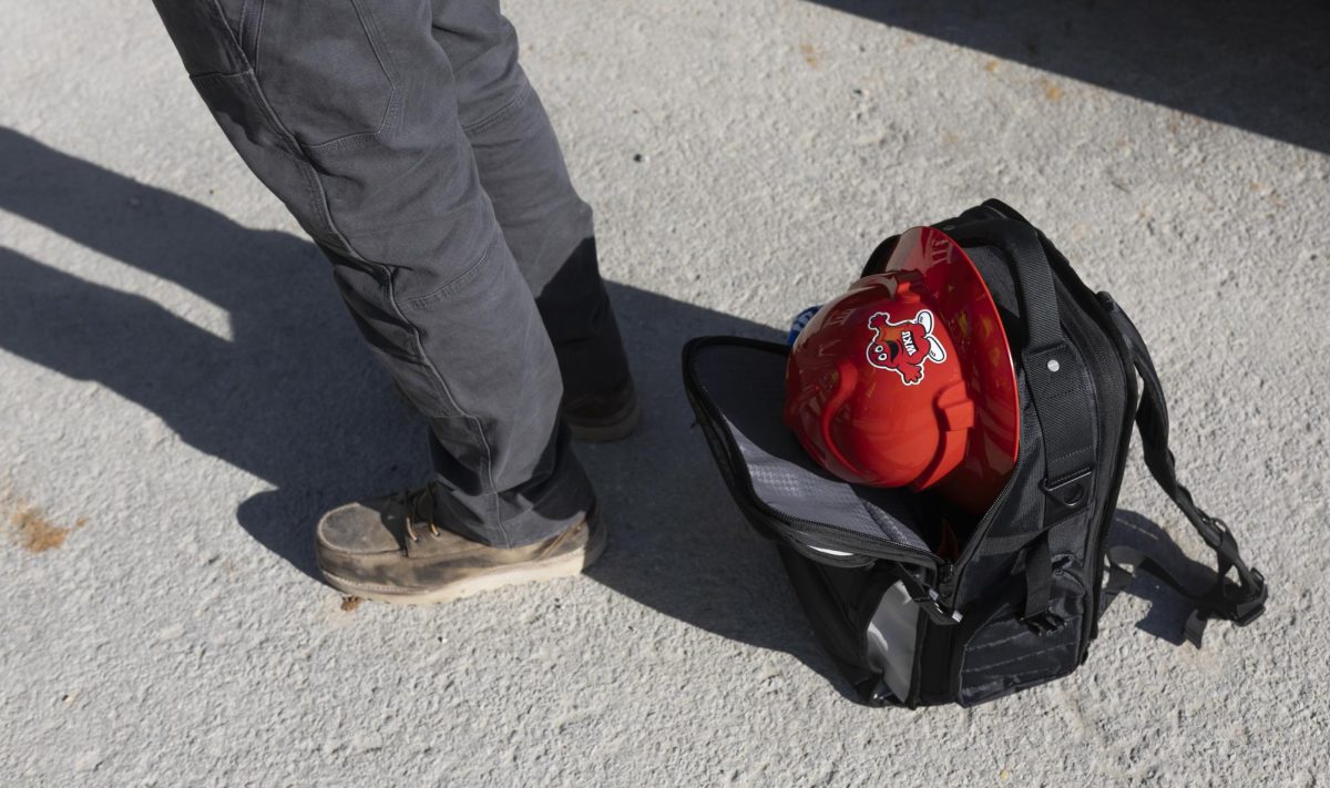 A member of the press has their Big Red hardhat in their backpack during the new Gordon Ford College of Business building walkthrough on Tuesday, Nov. 12, 2024.