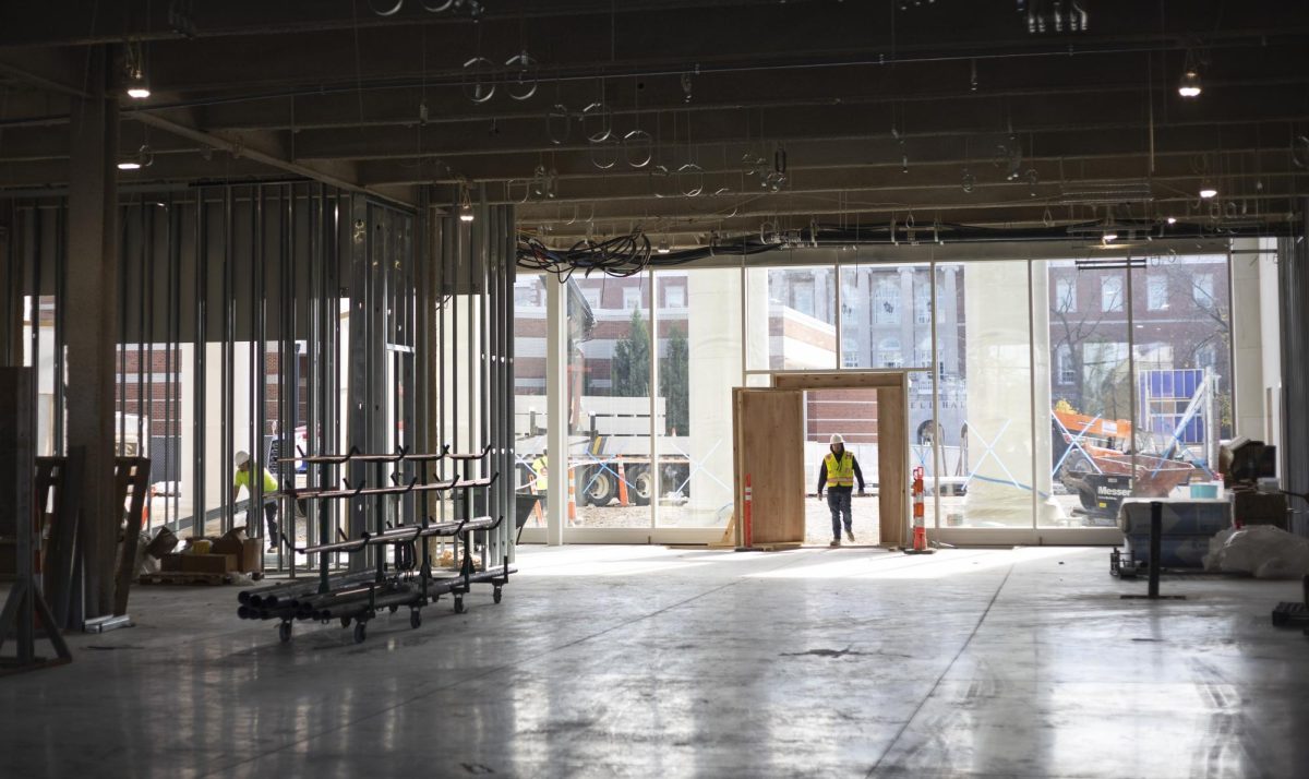 A construction worker walks through the opening of the new Gordon Ford College of Business building during a walkthrough on Tuesday, Nov. 12, 2024.