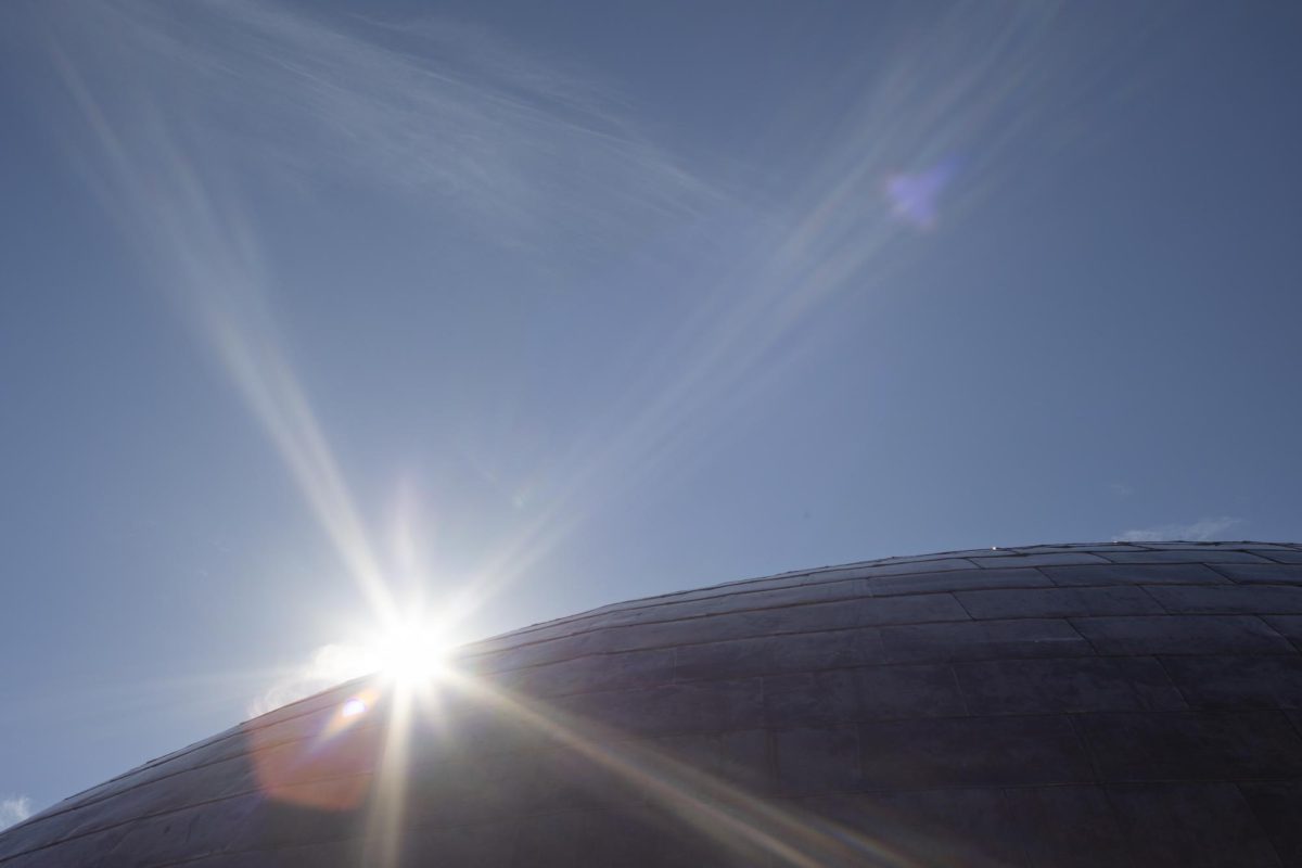 The sun peeks out behind the completed dome on top of the Gordon Ford College of Business building on Tuesday, Nov. 12, 2024.