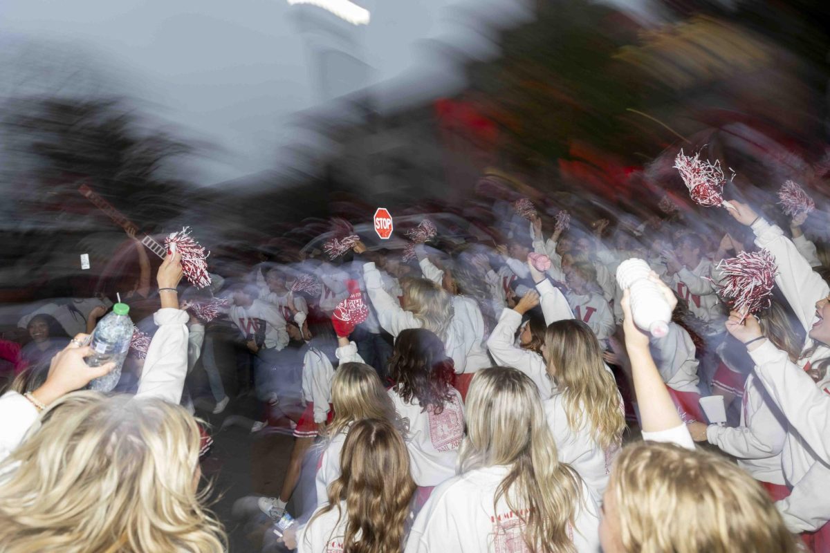 Members of Alpha Delta Pi cheer as the spirit stick passes by them before the 2024 WKU Homecoming parade on Friday, Nov. 15, 2024.