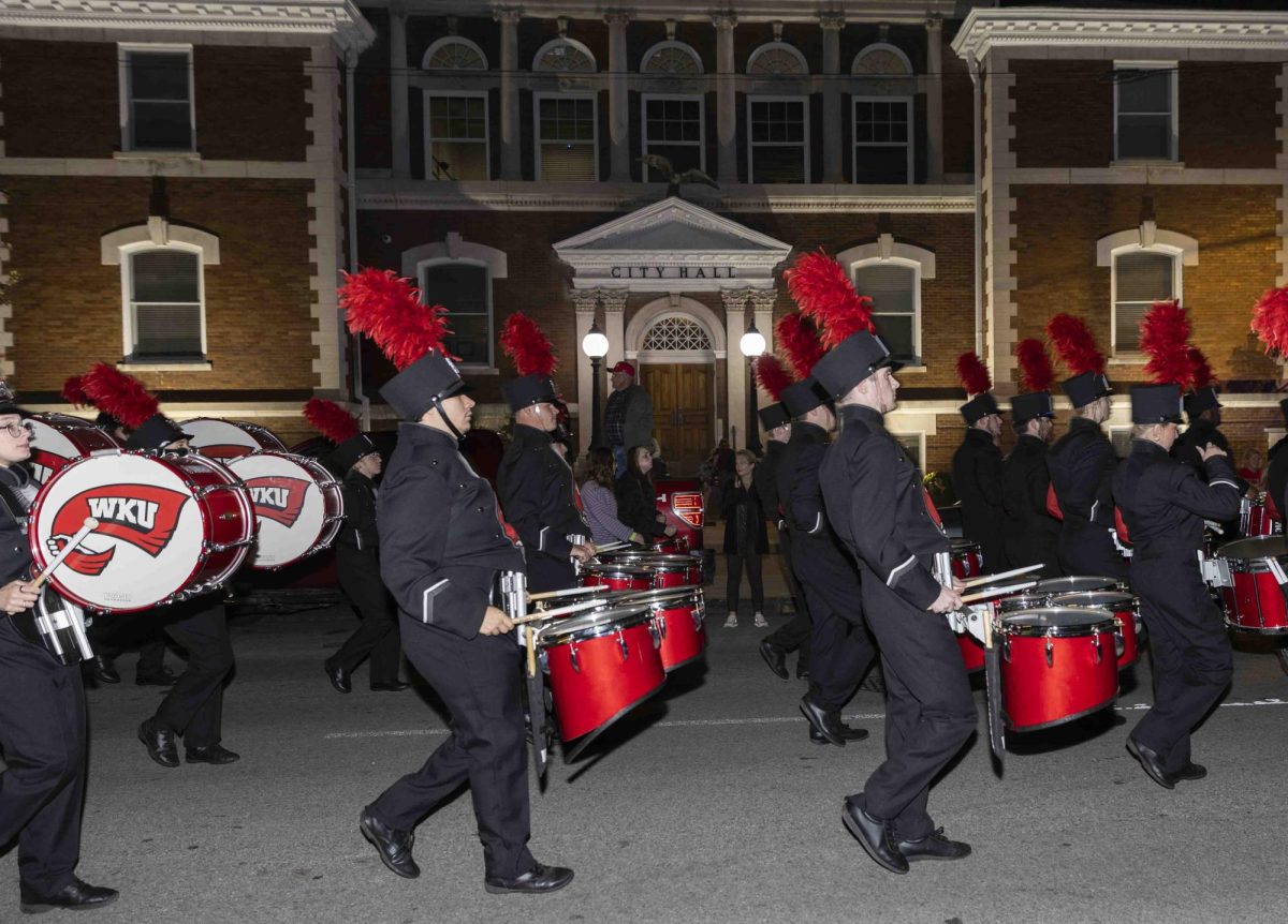 The Big Red Marching Band passes by Bowling Green City Hall on College St. during the homecoming parade on Friday, Nov. 15, 2024.