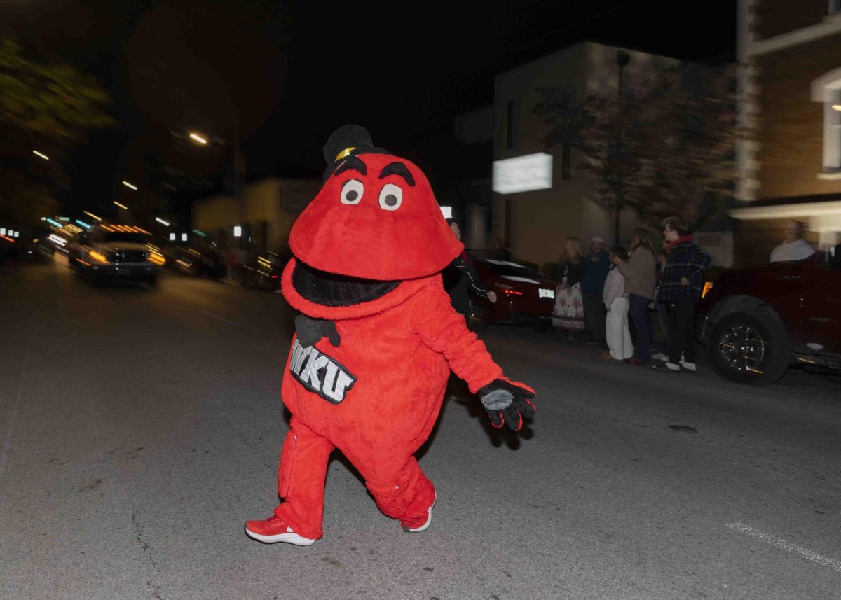 Big Red runs across College St. during the homecoming parade on Friday, Nov. 15, 2024.