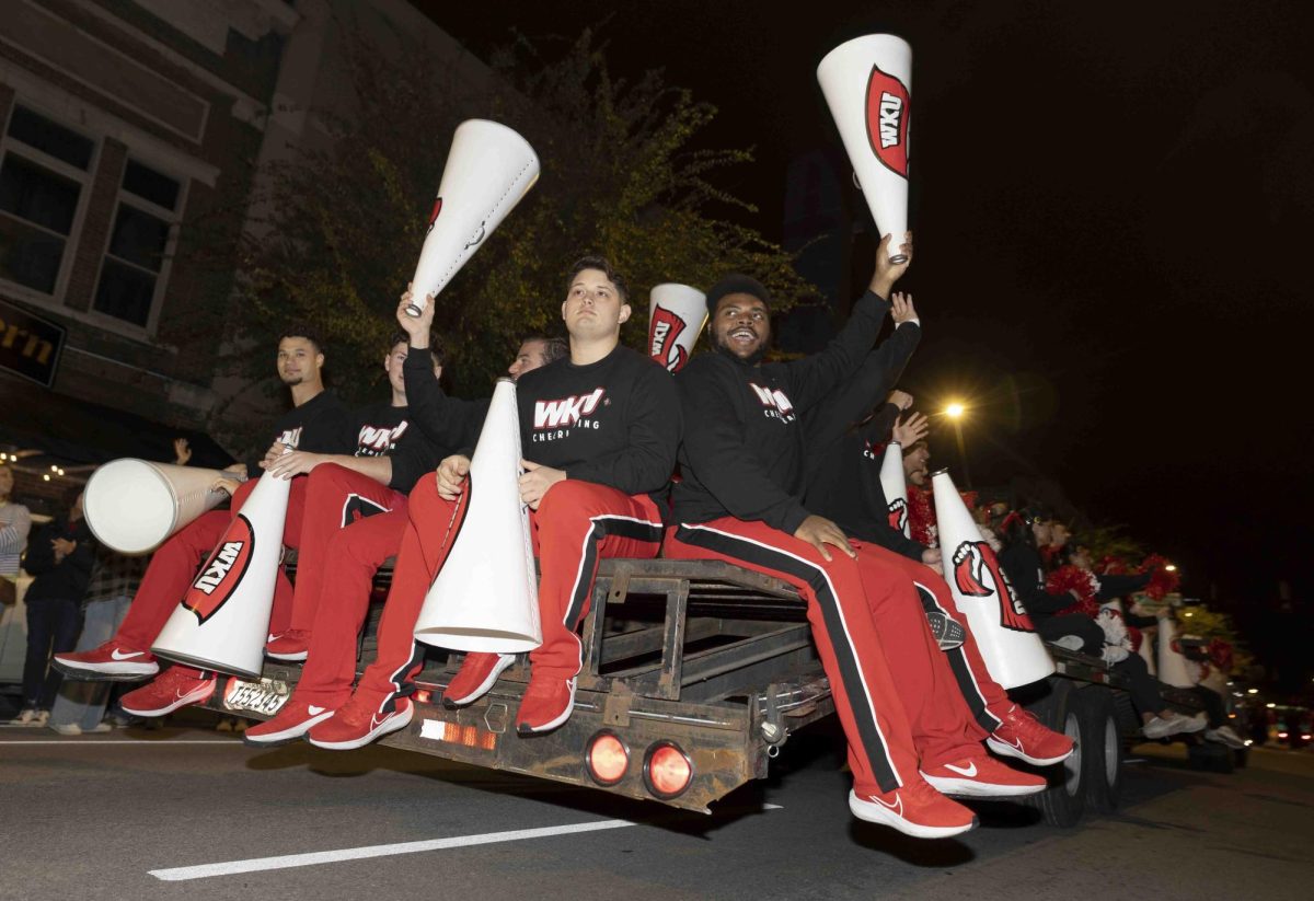 The WKU cheer team waves at the Bowling Green community during the homecoming parade on Friday, Nov. 15, 2024.