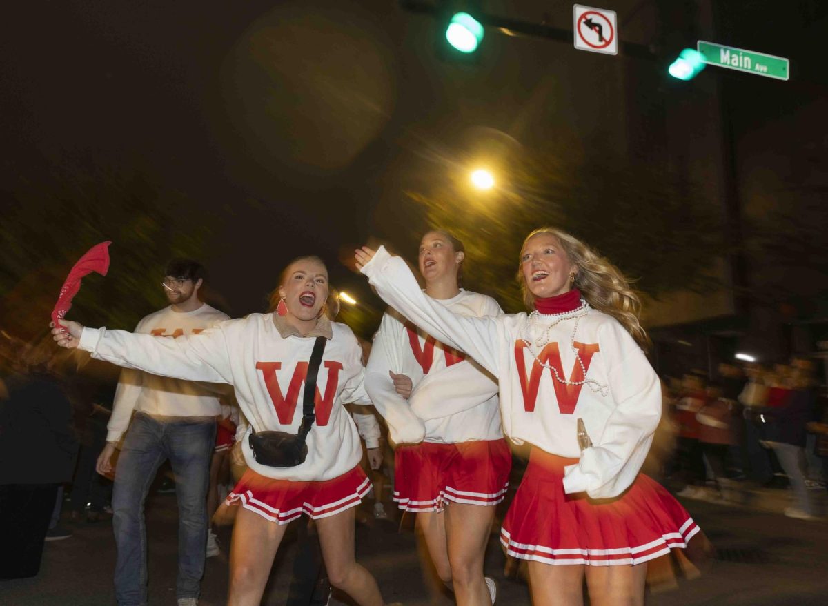 Alpha Delta Pi members Hannah Hamelback (left), Ashton Wyatt and Emma Jackson run towards the Bg Red Roar after the homecoming parade on Friday, Nov. 15, 2024.