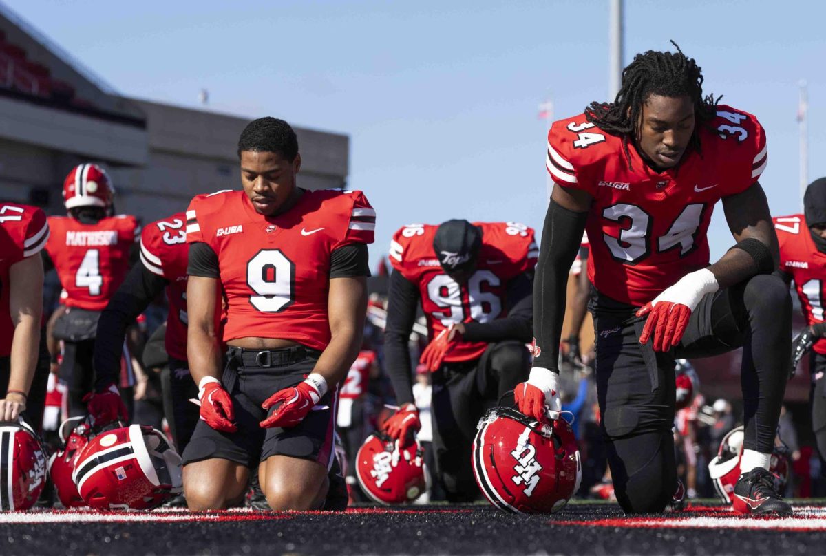 Western Kentucky Hilltoppers runningback George Hart III (9) kneels in the endzone with linebacker Koran Hayward (34) before the Homecoming football game in the L.T. Smith Stadium on Saturday, Nov. 16, 2024. 