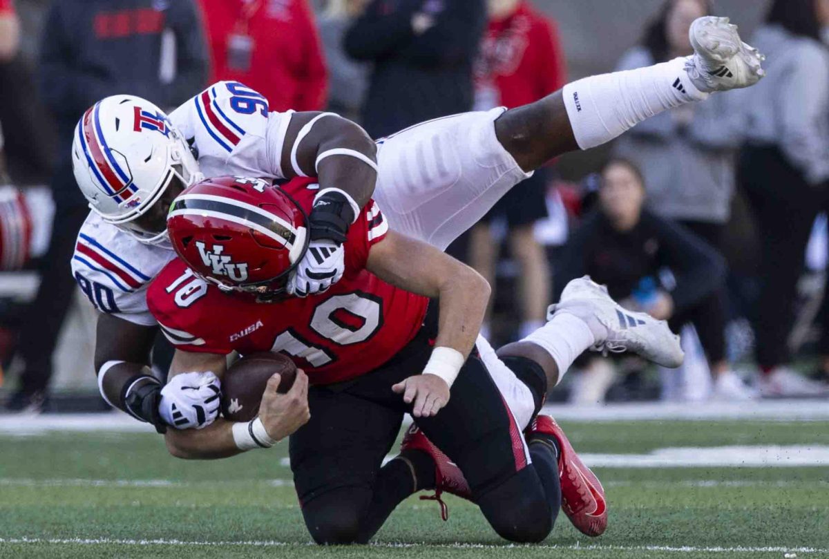 WKU quarterback Caden Veltkamp (10) is sacked by LA Tech defensive line David Blay (90) during the WKU Homecoming football game in the L.T. Smith Stadium on Saturday, Nov. 16, 2024. 