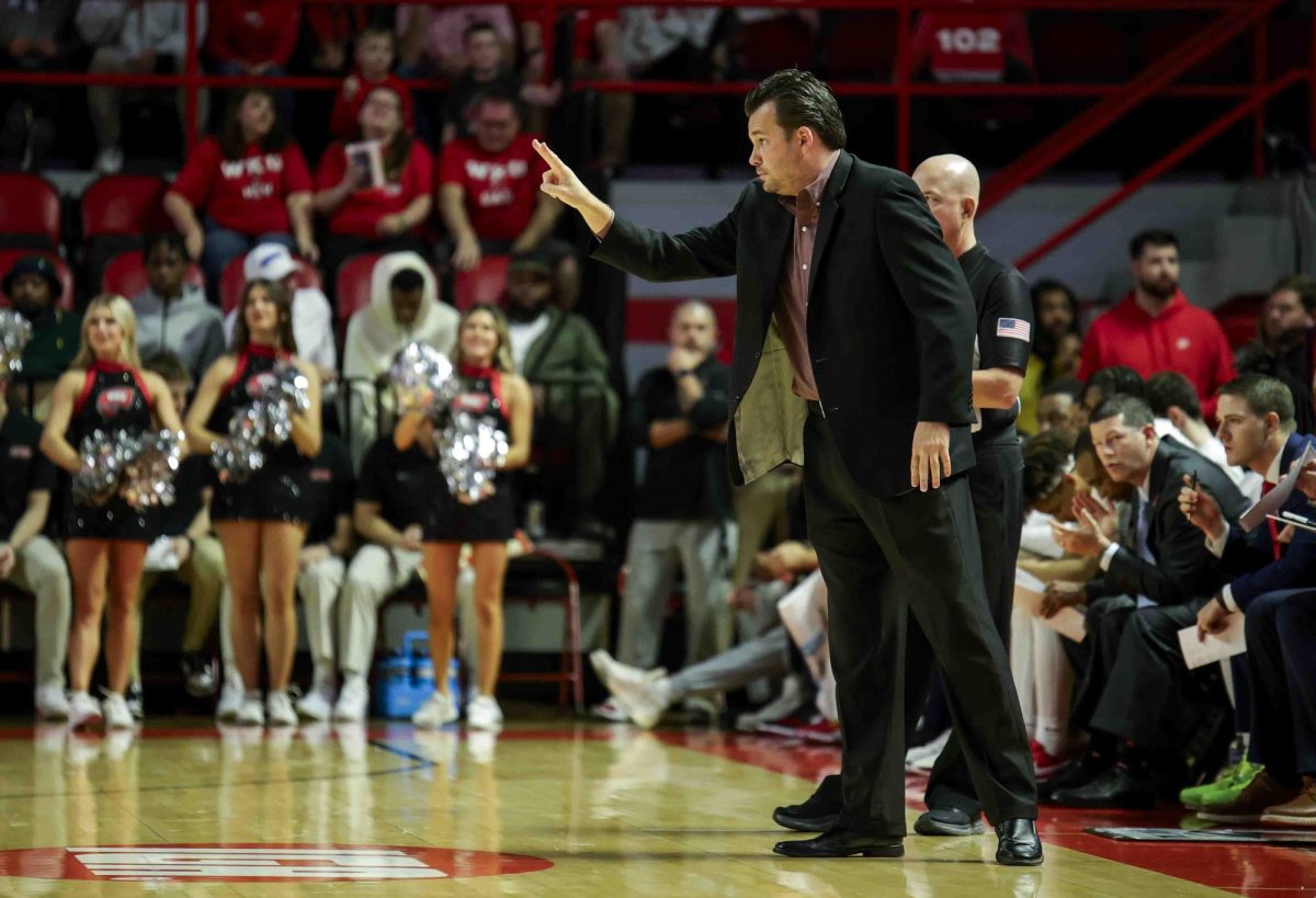 WKU head coach Hank Plona motions toward his moving offense during their game in Diddle Arena on Sunday, Nov. 17, 2024. 