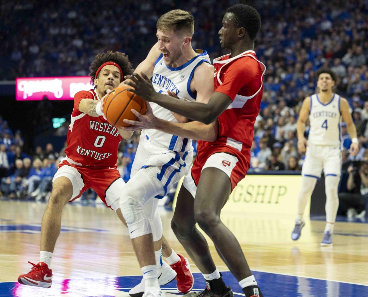 UK forward Andrew Carr (7) pushes back against WKu defense during the basketball game in Rupp Arena in Lexington, Ky., on Tuesday, Nov. 26, 2024.