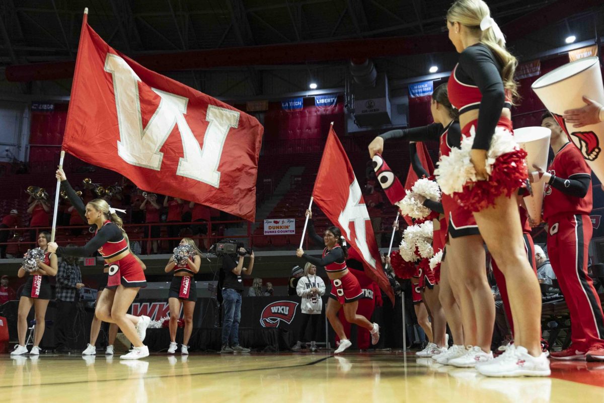 WKU cheerleaders run onto the court before the basketball team before the game in E.A. Diddle Arena on Saturday, Nov. 30, 2024. 