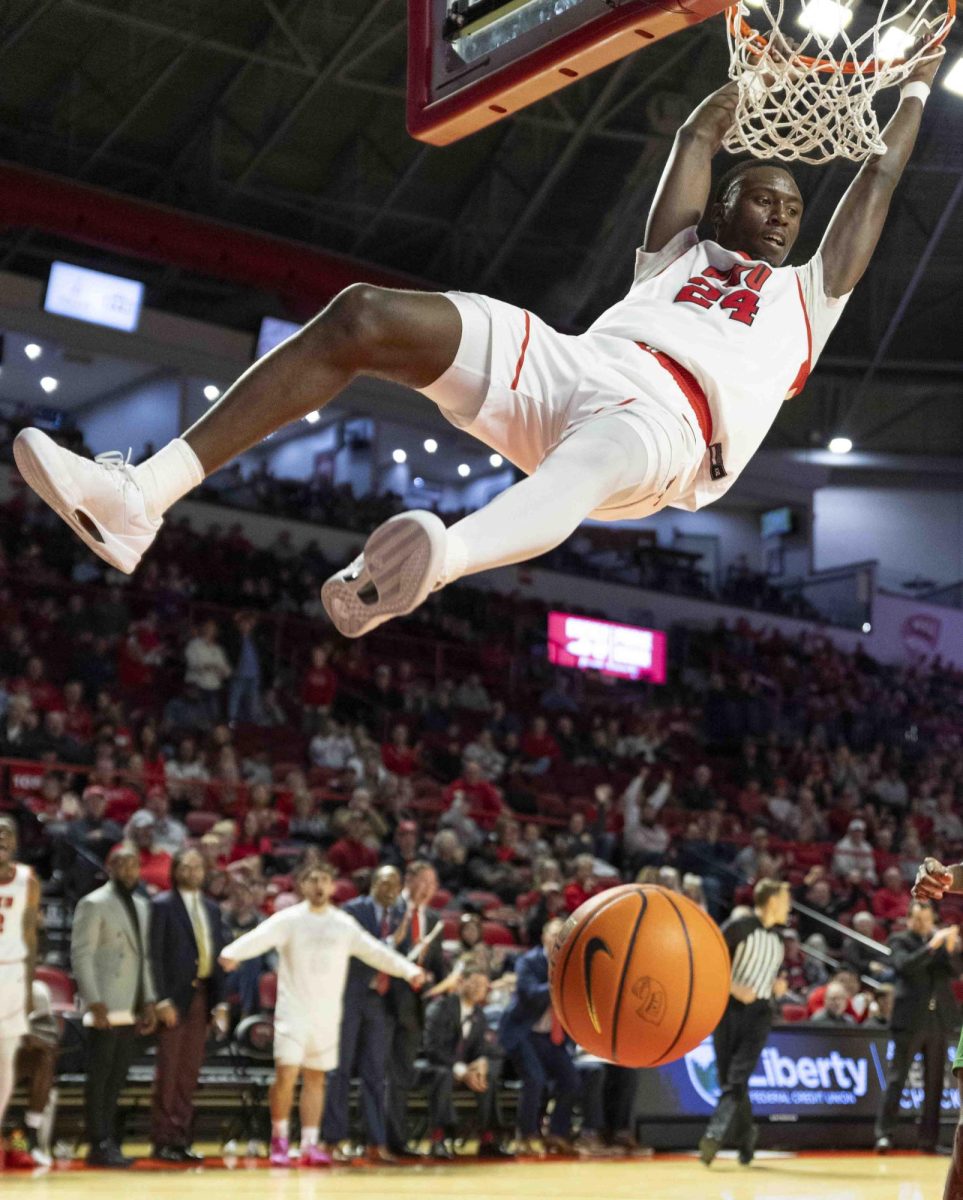 WKU forward Tyrone Marshall Jr. (24) hangs on the rim after a slam dunk during the basketball game in E.A. Diddle Arena on Saturday, Nov. 30, 2024. 