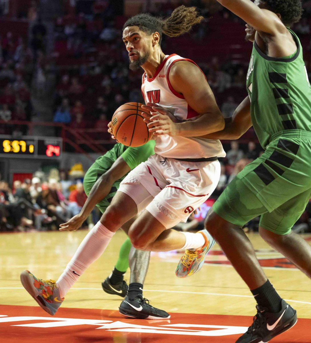 WKU guard Khristian Lander (4) drives through Marshall’s defense during the basketball game in E.A. Diddle Arena on Saturday, Nov. 30, 2024. 