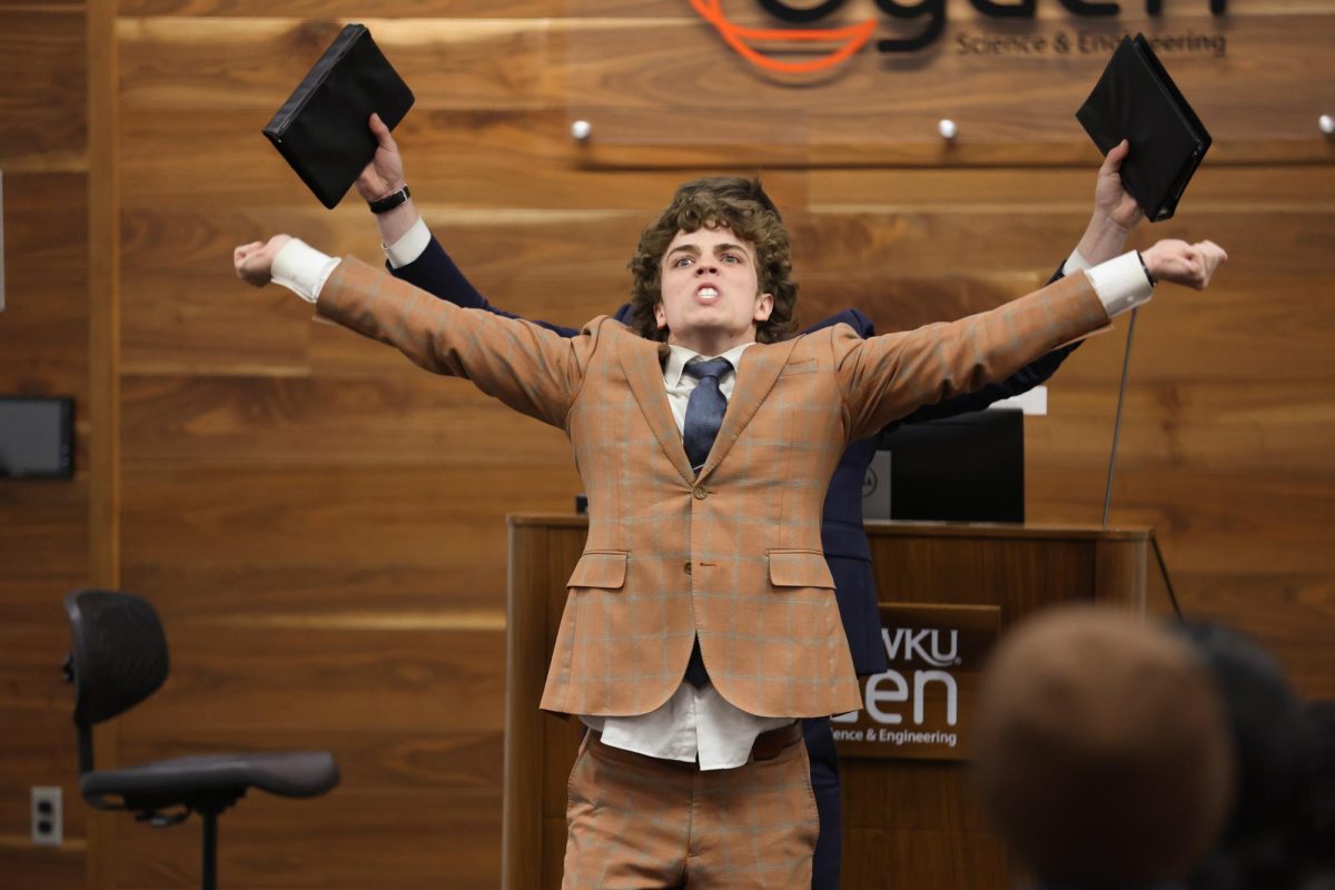 WKU Forensics Speech and Debate partners, Finn Larson and Jonah Johnson (front to back), perform their speech during the WKU Forensics Speech and Debate Showcase hosted on Thursday, Nov. 21, 2024. 