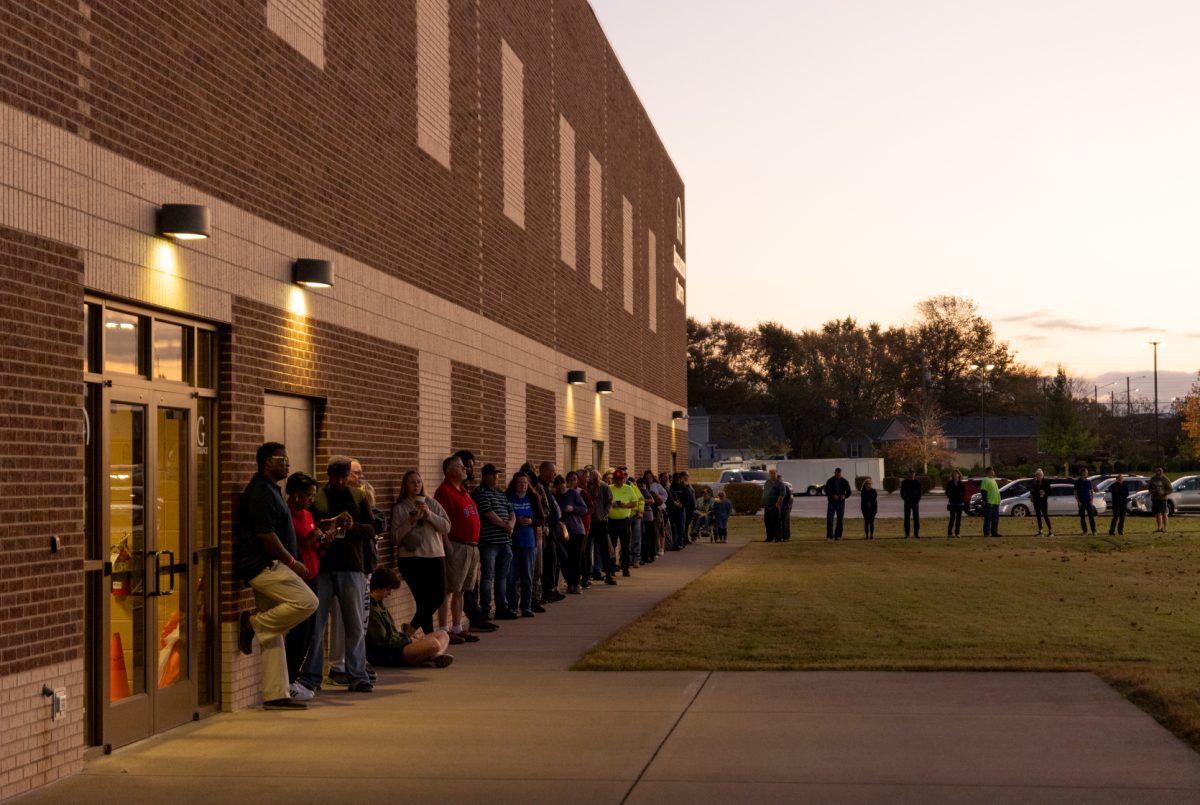 Voters stand outside Living Hope Baptist Church in the early morning hours before the polling location opened on Election Day, 2024.