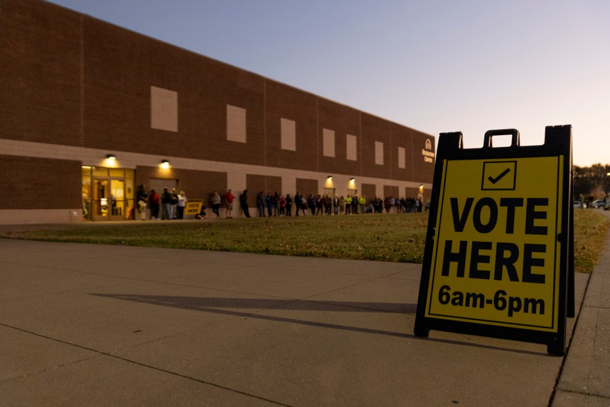 Voters stand outside Living Hope Baptist Church in the early morning hours before the polling location opened on Election Day, 2024.