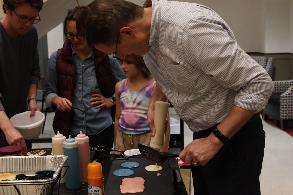 Dr. Rodney King, Interim Associate Director of Mahurin Honors College, pours pancake batter onto a stove for the annual Mahurin Honors College Pancake Night on Nov. 20, 2024. 