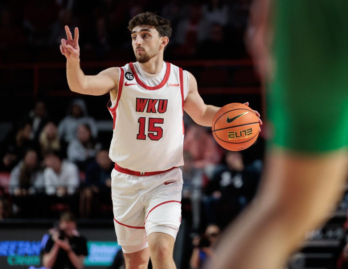 WKU guard Jack Edelen (15) motions to his teammates as he brings the ball up the court in the first half of the game against Marshall in E.A. Diddle Arena in Bowling Green, Ky., on Saturday, Nov. 30, 2024.