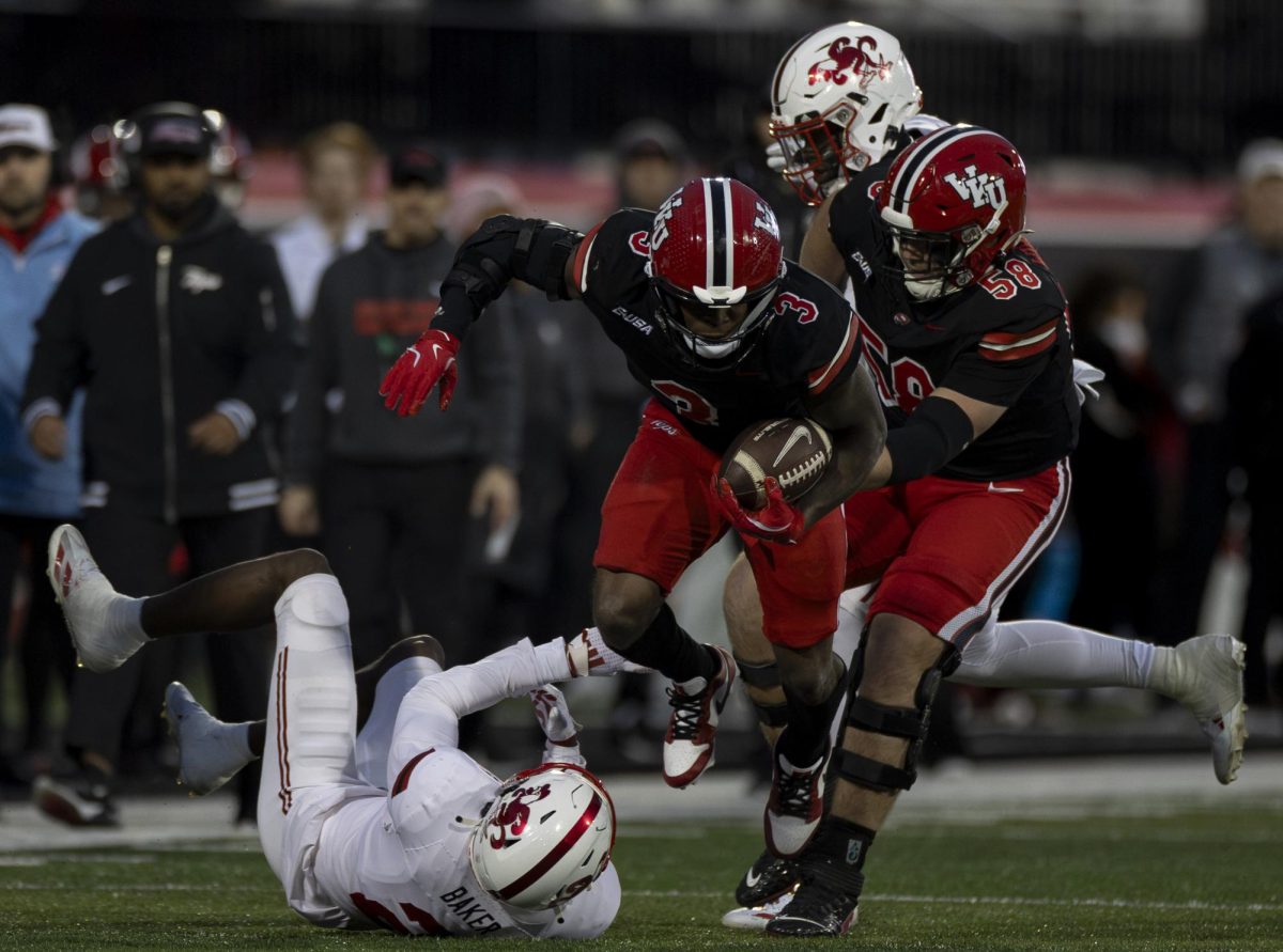 Western Kentucky running back Elijah Young (3) hops over a defender during WKU’s game against Jacksonville State in L.T. Smith Stadium in on Saturday Nov. 30, 2024. WKU won 19-17.